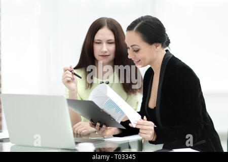 close up. business woman making notes sitting on her Desk Stock Photo
