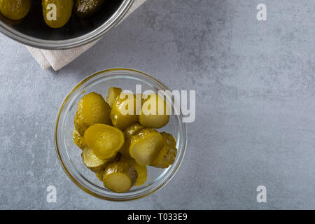 Homemade pickled fresh cucumbers, on a white background. Stock of food. Autumn concept. Top view, soft focus. Stock Photo