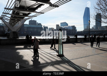 People strolling under the Millennium Bridge on Pauls Walk with a view of the River Thames from St Pauls Cathedral area in London EC4   KATHY DEWITT Stock Photo