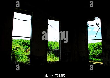 Three windows from an old abandoned ruins of a world war 11 building Stock Photo