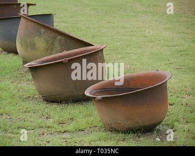 Vintage sugar kettles used in the 19th century plantations to cook sugar cane to produce sugar. Stock Photo