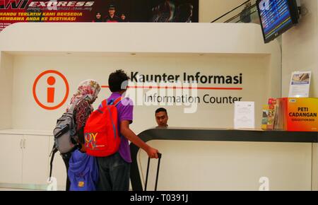 KUALA LUMPUR, MALAYSIA—MARCH 2016: Two people being assisted at the Information booth at the KL Sentral Station in Kuala Lumpur, Malaysia. Stock Photo