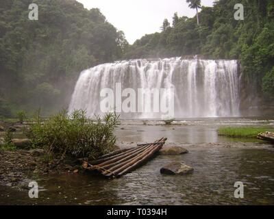 Front view of Tinuy-an Falls with a bamboo raft in the foreground. Tinuy-an Falls is popularly known as as the Niagara Falls of the Philippines Stock Photo