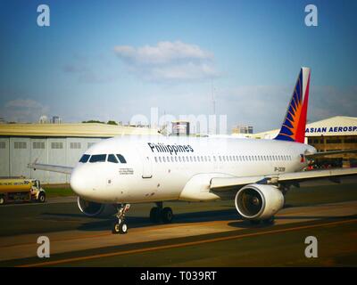 PASAY CITY, PHILIPPINES—MARCH 2016: A Philippine Airlines plane taxiing on the runway of the the Ninoy Aquino International Airport or NAIA. Stock Photo