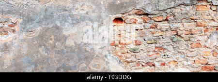 Old grungy red brick wall with peeled white beige stucco banner background. Vintage retro plaster wall with dirty cracked scratched texture background Stock Photo