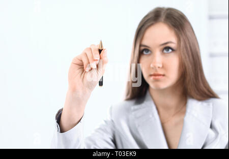 confident business woman pointing at a virtual point. Stock Photo