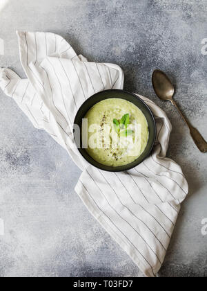 Vegetarian green cream soup of green peas with mint Stock Photo
