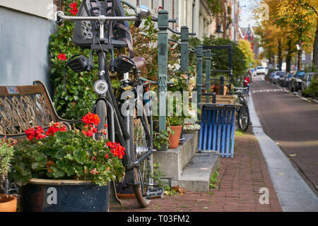 Retro bicycle and flowers on a street in Amsterdam Stock Photo