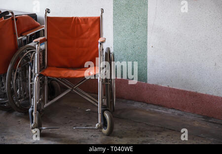 supporting wheelchairs for elderly, senior citizen, disabled in corner background, used when walking is difficult or impossible due to illness, injury Stock Photo