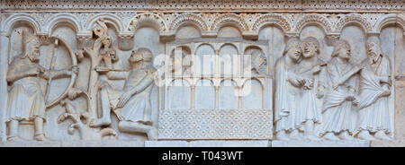 MODENA, ITALY - APRIL 14, 2018: The romanesque relief of Noah in his Arc and sons on the facade of Duomo di Modena. Stock Photo