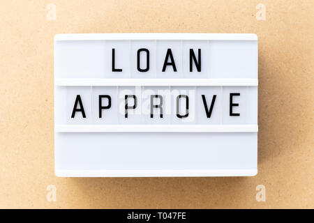 Light box with word loan approved on wood background Stock Photo