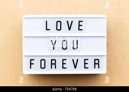 Light box with word love you forever on wood background Stock Photo