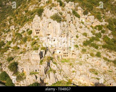 High angle drone aerial view of rock cut tombs carved into cliffside in Myra, Turkey Stock Photo