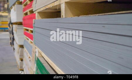 Lots of thin sheets of plywoods on the cabinet with different colors on each batches Stock Photo