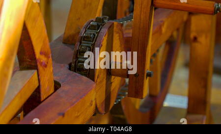 The wooden wheel and the chains of the crafted art of Leonardo Da Vinci inside the museum in Venice Italy Stock Photo