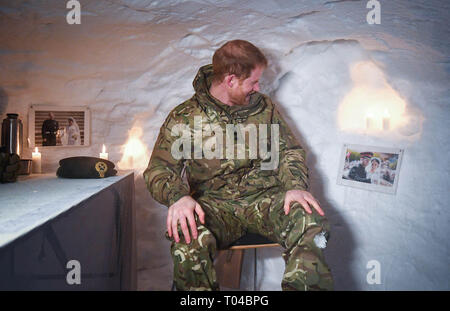 Prince Harry sits in an igloo and gazes at a photograph of himself and his wife Meghan Markle, Duchess of Sussex, from their wedding day.  Prince Harry, Captain General of the Royal Marines, visits Bardufoss Air Force Base on the 50th anniversary of Operation Clockwork, the Arctic warfare training exercise.  Featuring: Prince Harry, Harry Duke of Sussex Where: Bardufoss, Norway When: 14 Feb 2019 Credit: John Rainford/WENN Stock Photo