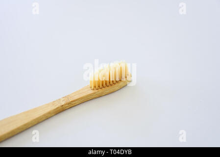 Wooden bamboo toothbrush close-up on grey background Stock Photo