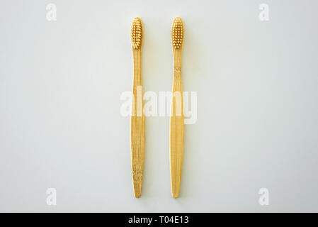 Two bamboo wooden toothbrushes on light grey background Stock Photo