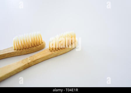 Two bamboo wooden toothbrushes on light grey background Stock Photo