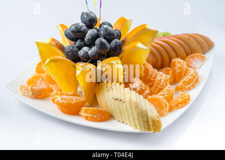 Mixed fruit in white plate isolated on white background - Healthy food style Stock Photo