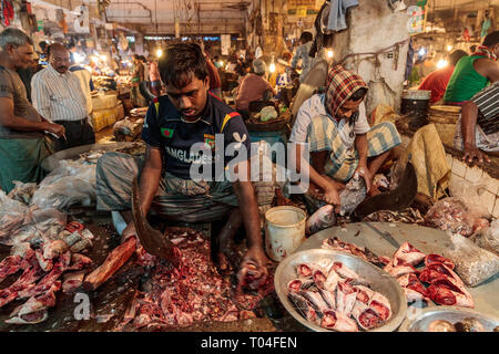 Colorful meat market with vendors trading and people transporting goods in the streets of Dhaka, Bangladesh Stock Photo