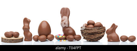 Delicious chocolate Easter bunny, eggs and sweets on white background Stock Photo