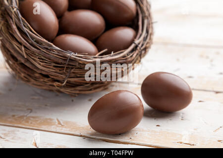 Delicious chocolate Easter holiday egg on rustic background Stock Photo