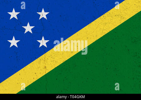 Solomon Islands flag on concrete wall. Patriotic grunge background. National flag of Solomon Islands Stock Photo