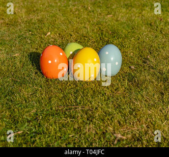 Colorful ceramic easter eggs lying on a meadow. Stock Photo
