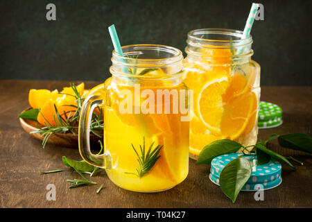 Cold summer drink set. Refreshing summer berry Lemonade, lemon mint Tea and orange Lemonade with rosemary. Stock Photo