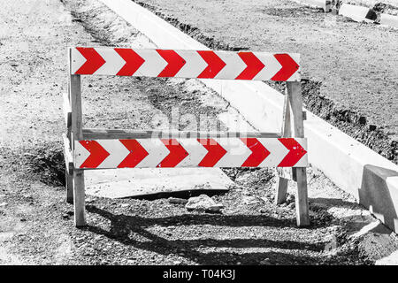 Road closed sign before the road construction. The black-and-white photo with red shooters Stock Photo