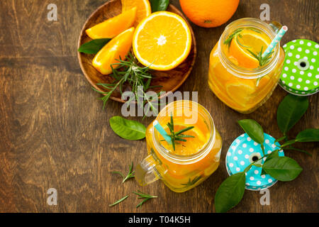 Cold summer drink set. Refreshing summer berry Lemonade, lemon mint Tea and orange Lemonade with rosemary. Copy space. Stock Photo