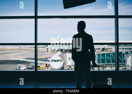 One passenger walking through the airport after arriving at Manchester ...