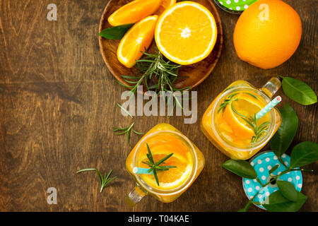 Cold summer drink set. Refreshing summer berry Lemonade, lemon mint Tea and orange Lemonade with rosemary. Top view flat lay background with copy spac Stock Photo