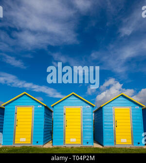 Beach huts on Felpham greensward on a sunny Spring day near Bognor Regis, West Sussex, UK Stock Photo