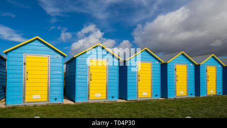 Beach huts on Felpham greensward on a sunny Spring day near Bognor Regis, West Sussex, UK Stock Photo