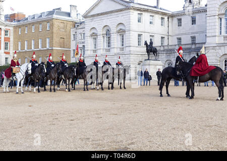 When The Queen is in London, the Long Guard consists one Officer, one Corporal Major, two Non-Commissioned Officers, one Trumpeter, and ten Troopers Stock Photo