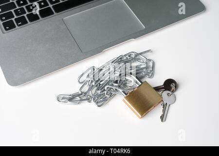 Padlock, chain and keys with laptop computer isolated on a white background. Cyber security abstract concept. Stock Photo