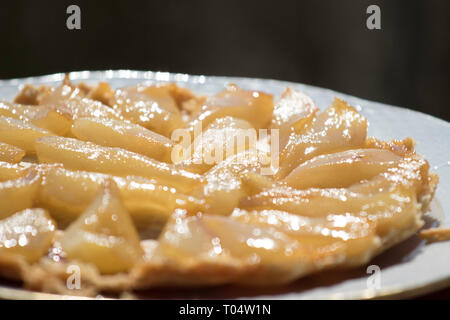 Spring, still life, violet, laburnum,  cake, pear tatin Budapest March 17, 2019 Stock Photo