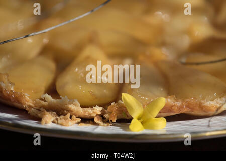 Spring, still life, violet, laburnum,  cake, pear tatin Budapest March 17, 2019 Stock Photo