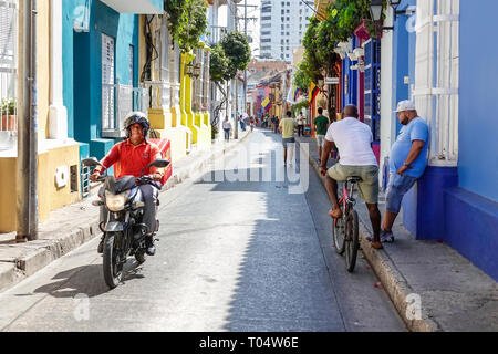Cartagena Colombia,Center,centre,San Diego,Hispanic resident residents,man men male,motorcycle rider,colorful facades,colonial homes,narrow street,COL Stock Photo