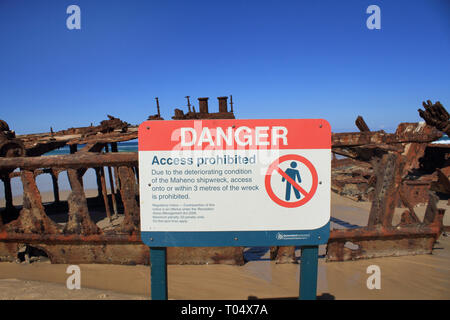 danger sign - The SS Maheno ship wreck on Fraser Isand.   It was wrecked when washed ashore by a cyclone in 1935 when it was being towed from Sydney t Stock Photo