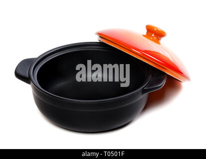 Open black pot for stove with red lid. Isolated on white background. Stock Photo