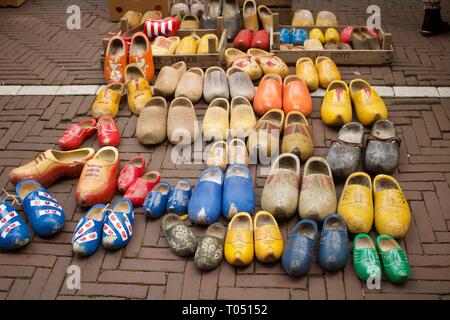 Selection of second hand clogs displayed for sale on ground Stock Photo