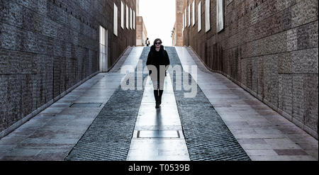 Belem, Lisbon / Portugal - 12 28 2018: Young white woman with small backpack walking through the museum of contemporary art Stock Photo