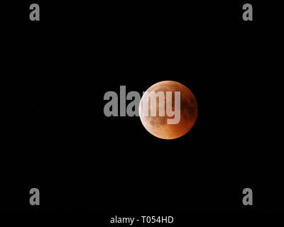 Amazing Blood Moon during longest total Lunar Eclipse of XXI century on black sky from Poland in 2018 Friday July 27 Stock Photo