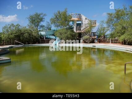 Abandoned waterpark with slides and a swimming pool on Rota, Northern Mariana Islands Stock Photo