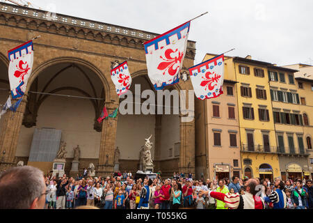 A parade of traditional flag throwers march in the Piazza della Signoria near the Palazzo Vecchio, the town hall in Florence, Tuscany, Italy. Stock Photo