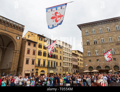 A parade of traditional flag throwers march in the Piazza della Signoria near the Palazzo Vecchio, the town hall in Florence, Tuscany, Italy. Stock Photo