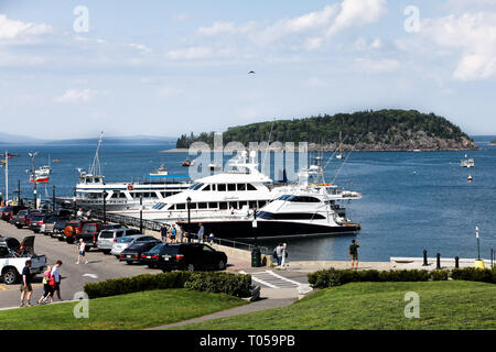BAR HARBOR, MAINE, USA - AUGUST 6, 2010:  Nice day with blue sky in Bar Harbor with tourists visiting pier at Frenchman Bay in Maine. Stock Photo